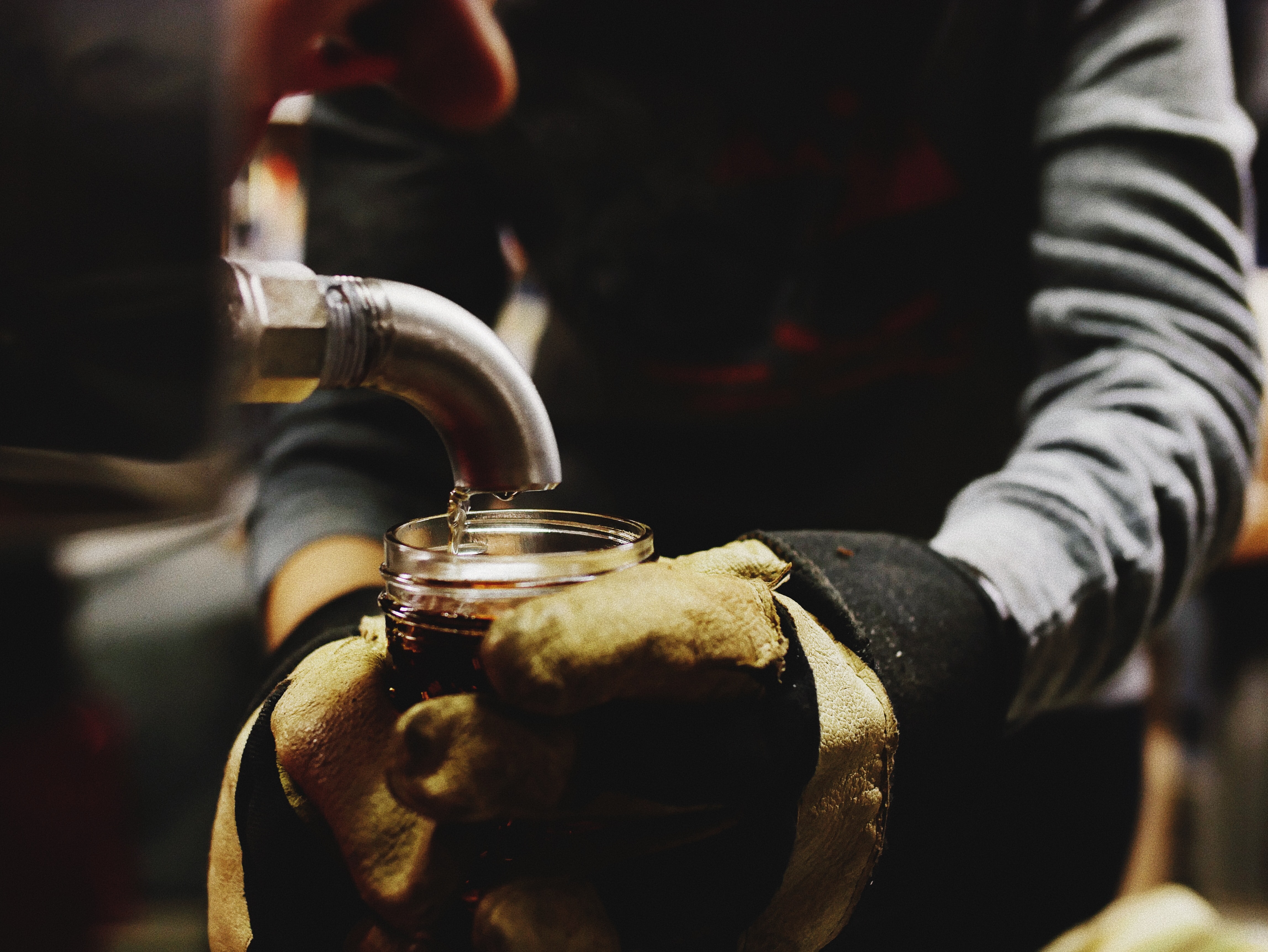 Maple syrup dripping in a jar